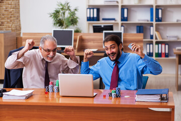 Sticker - Two male employees playing cards at workplace