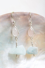 Wall Mural - Raw stone mineral earrings on white background