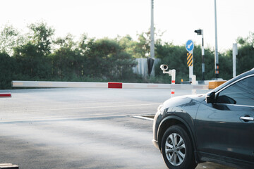 Black car accessing to open gate and entrance and exit from village , Security and safety concept.