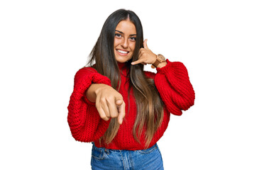 Wall Mural - Beautiful hispanic woman wearing casual clothes smiling doing talking on the telephone gesture and pointing to you. call me.