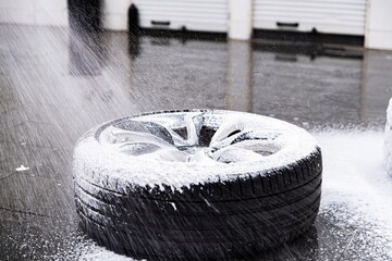 Wall Mural - Cleaning car wheel and tire with active foam and pressure washer