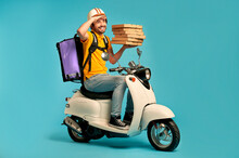 Young Courier, Pizza Delivery Man In Uniform With Thermo Backpack On A Moped Isolated On Blue Background. Fast Transport Express Home Delivery. Online Order.