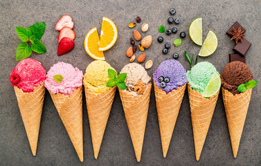 Fototapete - Flat lay ice cream cones collection on dark stone background . Blank crispy ice cream cone with copy space for sweets menu design.