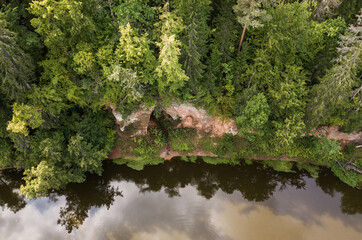 Wall Mural - Boat trip down the river Salaca. Beautiful sand stone cliffs, Latvia. Captured from above.