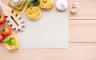 Wall Mural - Food background for tasty Italian dishes with blank brown paper and vintage pasta ladle on wooden background. Top view italian foods concept and menu design with copy space.