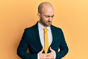 Sticker - Young hispanic man wearing business suit and tie with hand on stomach because indigestion, painful illness feeling unwell. ache concept.