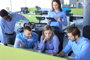 Wall Mural - Team young professionals having casual discussion in office. Executives having friendly discussion during break.