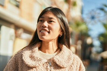 Sticker - Young asian woman smiling happy standing at the city.