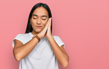 Sticker - Young asian woman wearing casual white t shirt sleeping tired dreaming and posing with hands together while smiling with closed eyes.