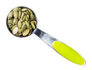 peeled pumpkin seeds in measuring spoon cutout