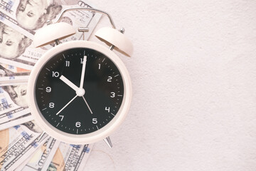 old alarm clock and us dollar cash on white 