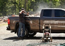 Man Spray Washing Pickup Truck