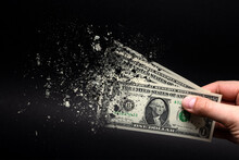 Inflation, Dollar Hyperinflation With Black Background. One Dollar Bill Is Sprayed In The Hand Of A Man On A Black Background. The Concept Of Decreasing Purchasing Power, Inflation.