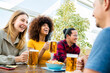 © Davide Angelini - Happy multiracial friends group drinking beer at brewery pub restaurant - Friendship concept with young people having fun and laughing together - Focus on black woman