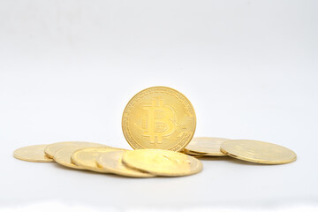 Business , Money, Technology and  cryptocurrency Concept. Closeup of gold bitcoin coin with pile of coins isolated on white background.