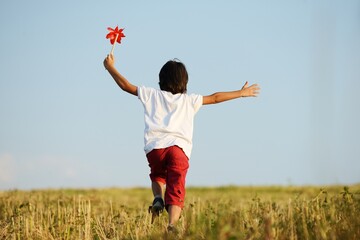 Happy kid running on beautiful field