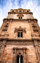 Wall Mural - Tower bell, clock and carved stone details of the Cathedral of Murcia