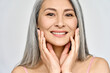 Closeup portrait of gorgeous happy middle aged mature asian woman, senior older 50 year lady looking at camera touching her face isolated on white. Ads of lifting anti wrinkle skin care, spa.