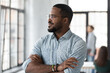 © fizkes - Successful African American startup leader looking out window with hands crossed. Millennial business owner thinking of future and profit. Employee dreaming of career success. Head shot portrait