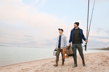 Poster - Father and son with fishing equipment walking on riverside