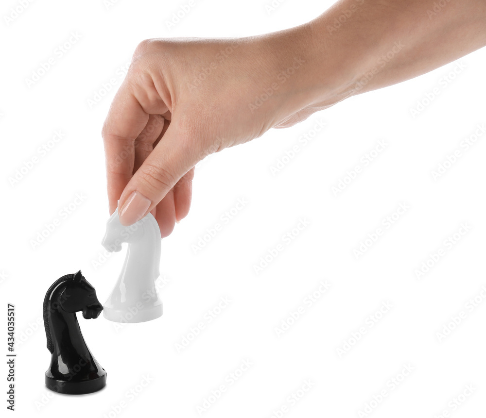 Female hand with chess pieces on white background