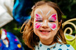 © Marcel Poncu - little girl having her face painted for kids party. Halloween or carnival family lifestyle Face painting, headshot close up