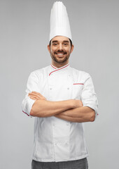 Wall Mural - cooking, culinary and people concept - happy smiling male chef in toque and jacket with crossed arms over grey background