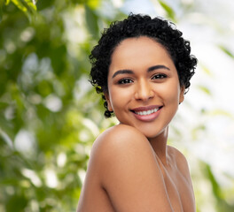 beauty and people concept - portrait of happy smiling young african american woman with bare shoulde