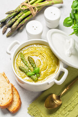 Canvas Print - Cream of asparagus soup. Prepared with asparagus, potato, onion and vegetable stock. Toast bread, uncooked ingredient on bacground. Vertical image.