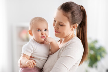 Wall Mural - family, motherhood and people concept - happy mother with little baby daughter at home