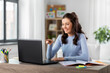 © Syda Productions - distant education, remote job and people concept - happy smiling female teacher with laptop computer having online class or video call at home office