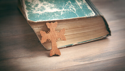 Wall Mural - Christian cross and Bible on the wooden background.