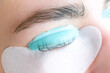 Young woman receiving eyelash lamination procedure