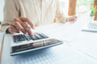 © ijeab - Male accountant or banker use calculator.