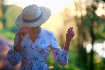 Wall Mural - happy romantic girl in a straw hat / young model in a dress summer day, happiness woman