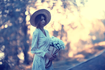 Wall Mural - girl in a straw hat portrait spring freedom / concept spring view model happy people