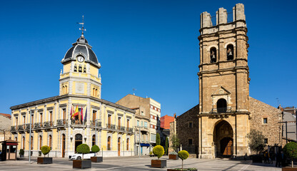 Wall Mural - Cityscape of old town La Bañeza in Castile and Leon, Spain, with historic town hall building and landmark Saint Mary church on the main town square.