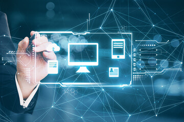 Poster - Hand with a pen touching a hologram desktop with different icons in it. Big data and technology concept