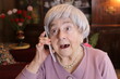 Surprised senior woman on the phone