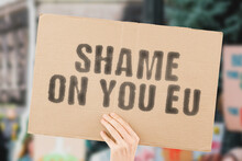 The Phrase " Shame On You EU " On A Banner In Hand With Blurred Background. Politics. Disagreement. European Union. Europe. Society. Disagree . Social Issue. Problem