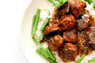 Sticker - Top view of meat with red sauce, rice and beans on a white plate