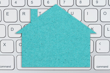 Wall Mural - Blank teal house sign on gray keyboard