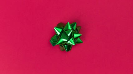 unwrapping gift revealing a green screen - stop motion animation - green bow on a red background