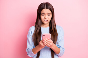 Sticker - Portrait of attractive worried focused girl using device browsing fake news isolated over pink pastel color background