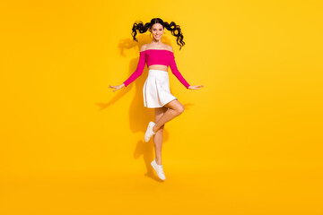 Sticker - Full size photo of optimistic lovely brunette lady jump wear pink top skirt isolated on yellow background