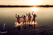 © Zoran Zeremski - Friends having fun enjoying a summer day swimming and jumping at the lake.