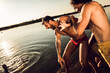 © Zoran Zeremski - Friends having fun enjoying a summer day swimming and jumping at the lake.