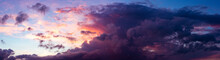 Panoramic View With Vibrant Blue Sky And Dramatic Sunset Contrasting Colors Of Yellow, Red And Orange Touching The Cumulus Cloud. Weather Conditions. Wallpaper Poster.