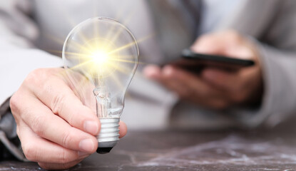 Poster - Hand holding light bulb and business ideas concept, technology innovation