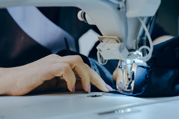 Wall Mural - Closeup shot of a worker sewing in a textile factory